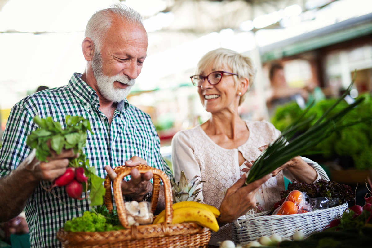casal de idosos comprando verduras